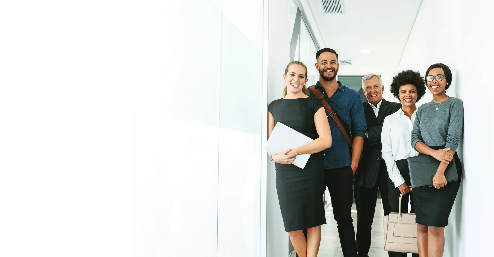 Employees smiling in an office hallway